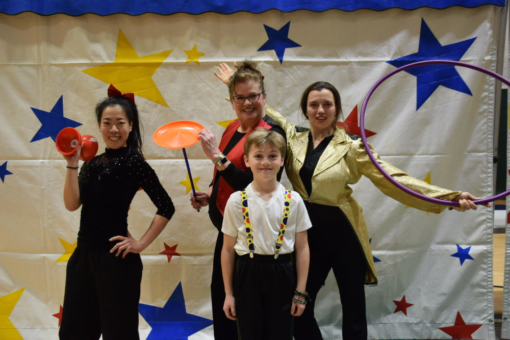 National Circus Project performers Tara, Mary Kelly and Joyce helped students like Declan Mueller (center) learn skills during the week before their final performance.