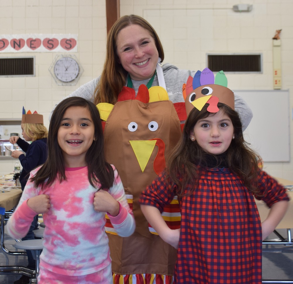 Mrs. Wasserman with two students at BP's Thanksgiving Feast.