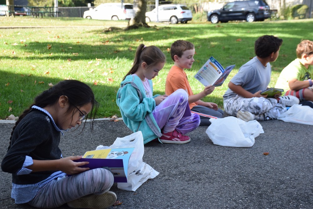 Students at Bayville Primary enjoy their new books.