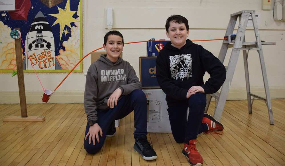 Bayville Intermediate School Fifth graders Michael Uber and Cooper James used a toy car to speed down a track and into a cup, pulling chips down into a bowl of salsa.
