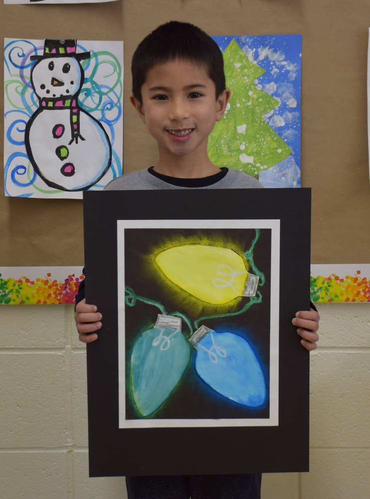First grade Bayville Primary School student Lucas Kim pictured with his glowing art piece that was selected for the Colors of Long Island Student Art Show.