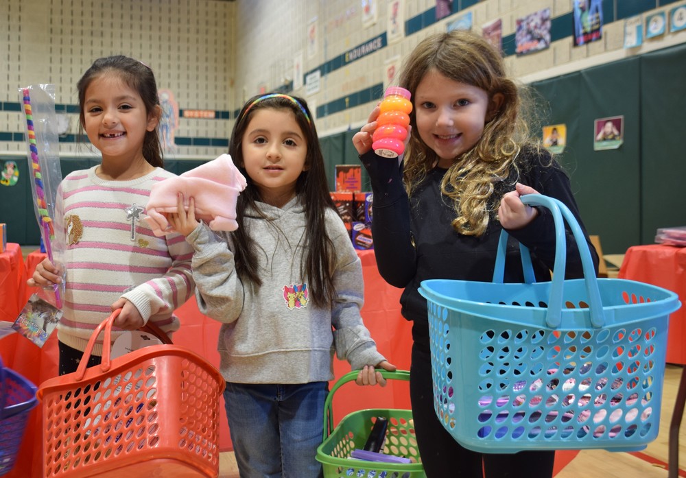 Three  Ann MacArthur Primary students  boy gifts for their loved ones at the LVEPC Holiday Boutique on Dec. 14.