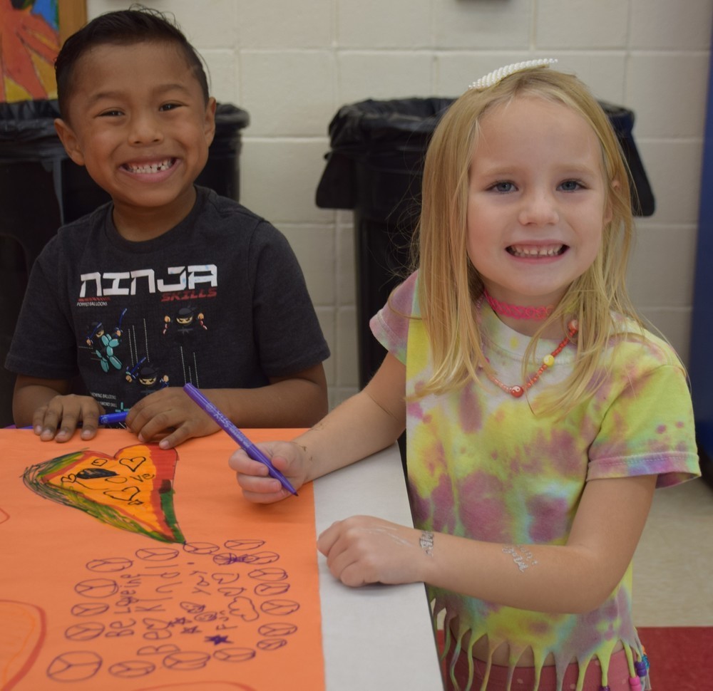 Students at AMP add to the Unity Day mural.