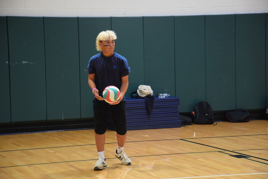 A member of the varsity soccer team prepares his serve.