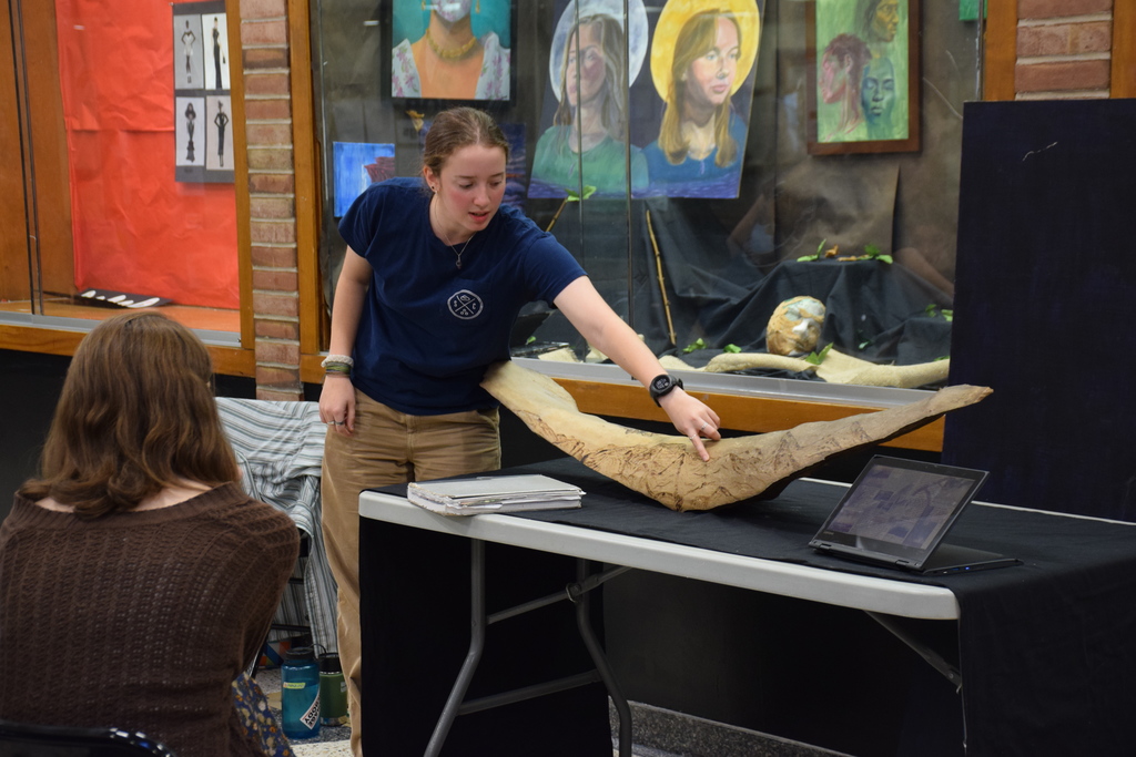 LVHS senior Clare Simon talks to fellow students about her IB Art works, including a wood carving project.