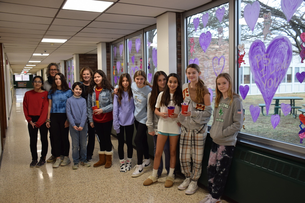 Locust Valley Middle School’s art club decorates a hallway with messages of kindness for their classmates.