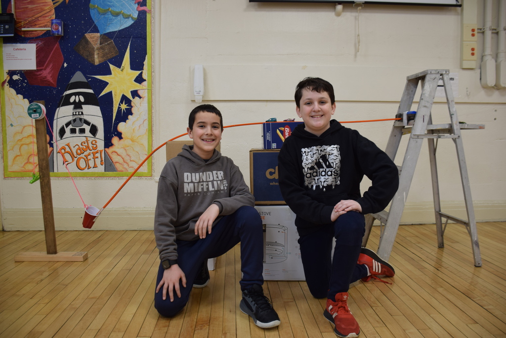 Bayville Intermediate School Fifth graders Michael Uber and Cooper James used a toy car to speed down a track and into a cup, pulling chips down into a bowl of salsa.