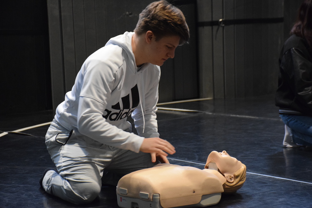 Locust Valley High School eleventh grader Spiro Lampoutis prepares to perform CPR on a dummy during physical education class.