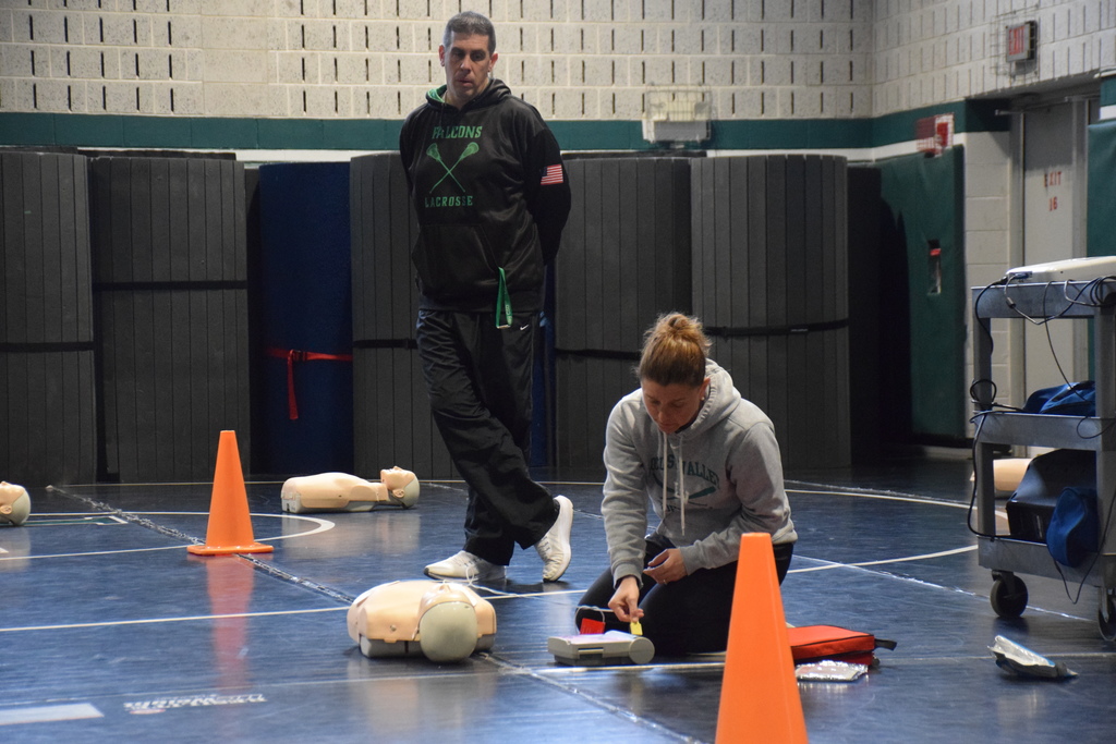 Locust Valley teachers Nadine Pacifico and Matthew McFarland teach middle and high school students how to use a defibrillator while performing CPR.