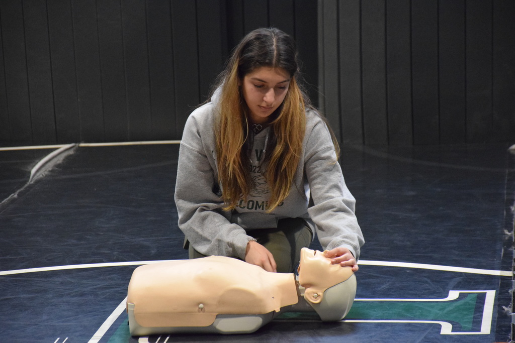 Gianna Spinelli, a twelfth grader, practices checking for breathing.