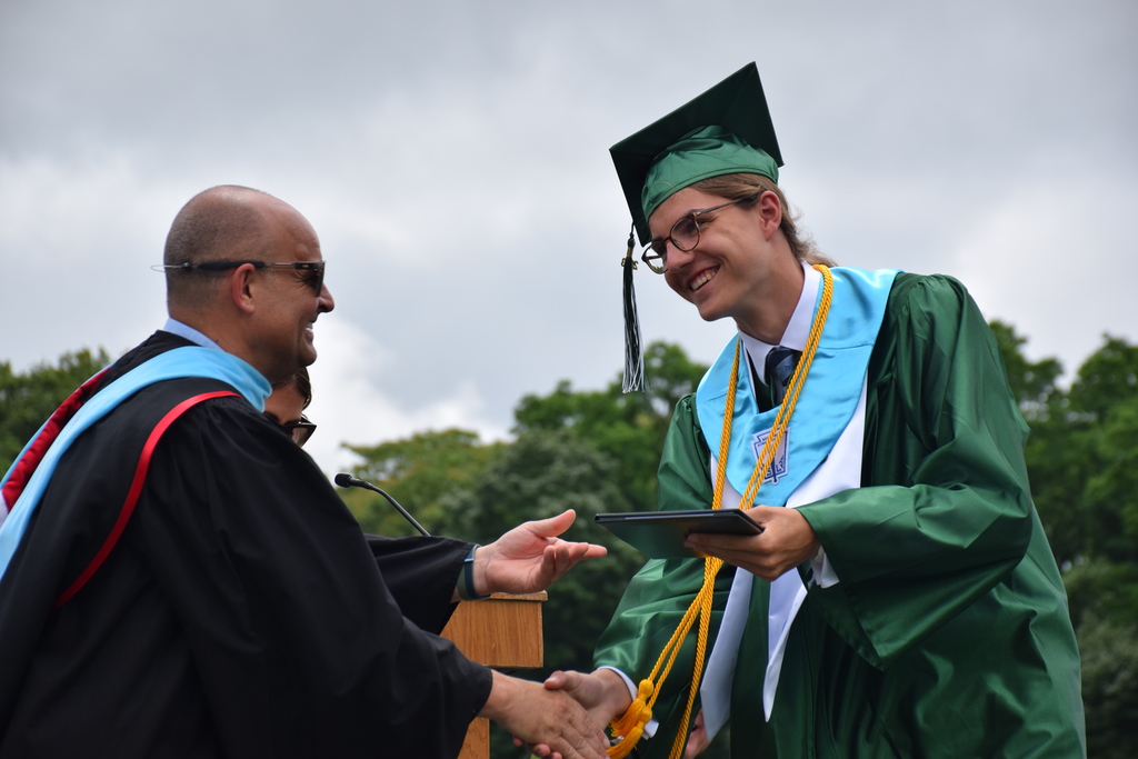 Locust Valley High School graduate Oliver Blaise gets his diploma from principal Patrick DiClemente.