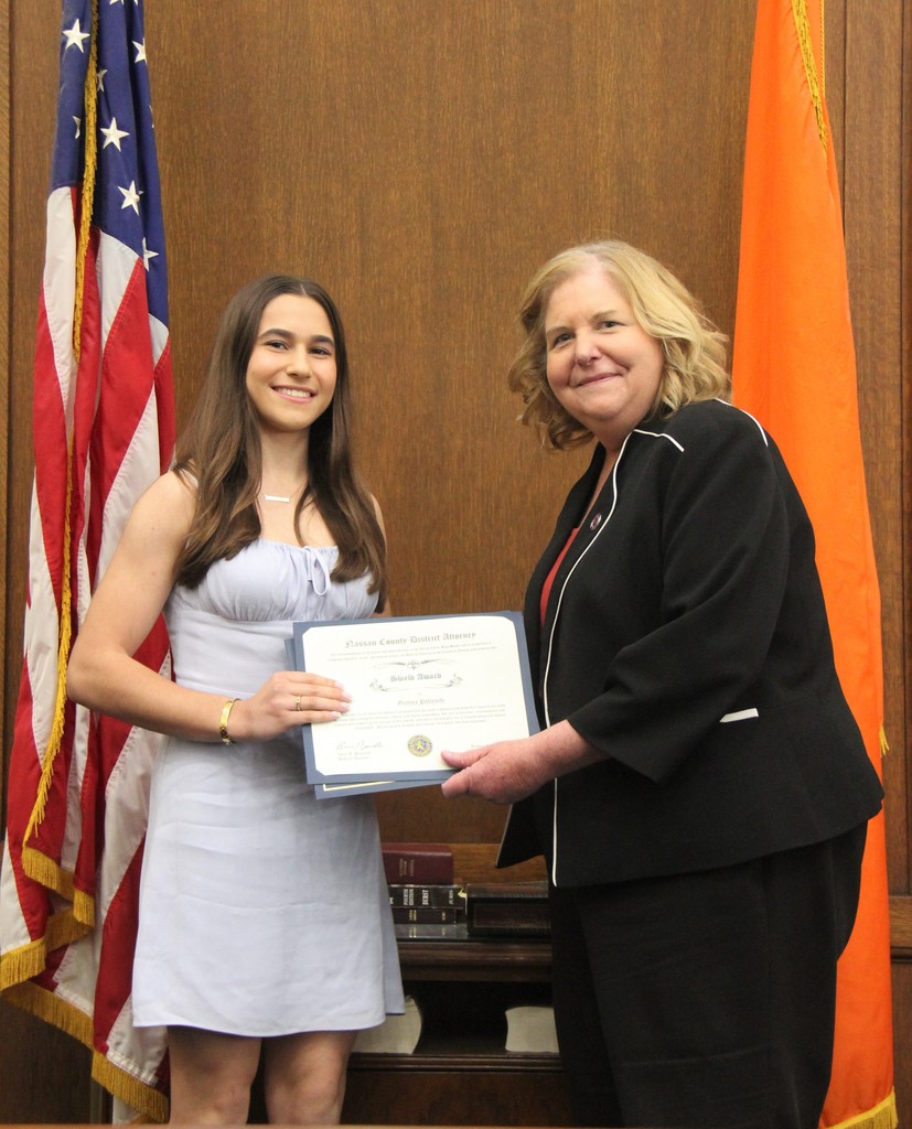 Locust Valley High School incoming senior Gianna Palleschi is honored with the SHIELD Award for her Pink Pom Pom boxes with Nassau County District Attorney Anne T. Donnelly.